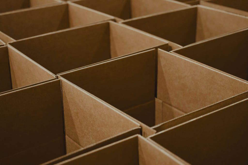 Business supplies and packaging consumables arranged on shelving, representing operational supply categories.