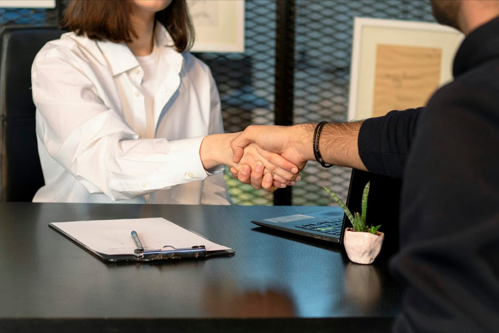 Two people in a business meeting, representing supplier and distributor trade discussions.